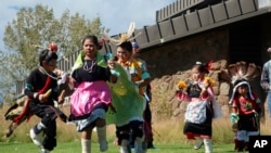 FILE - Hopi children dance in front of City Hall on Indigenous Peoples Day in Flagstaff, Ariz., Oct. 10, 2022.