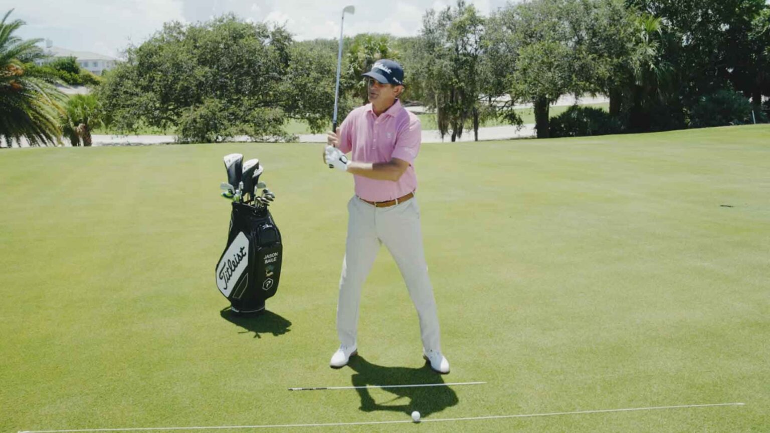 Golf instructor Jason Baile demonstrates a grip pressure tip