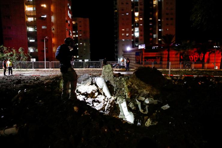 An Israeli rescue force member inspects the site where a projectile fell,amid cross-border hostilities between Hezbollah and Israel, in Haifa, Oct. 7. Reuters-Yonhap