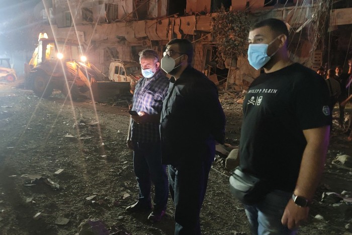 Mayor Ahmad Kaheel, centre, pictured at the scene of an air strike earlier this month in Nabatiyeh