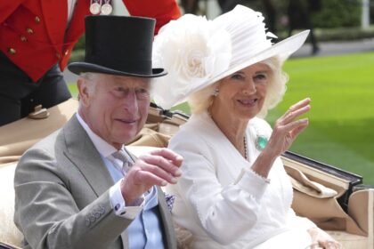 Britain's King Charles III and Queen Camilla wave to the crowds as they arrive by carriage in the parade ring on the third day of the Royal Ascot, horse race meeting, traditional known as Ladies Day, at Ascot, England, on June 20, 2024.