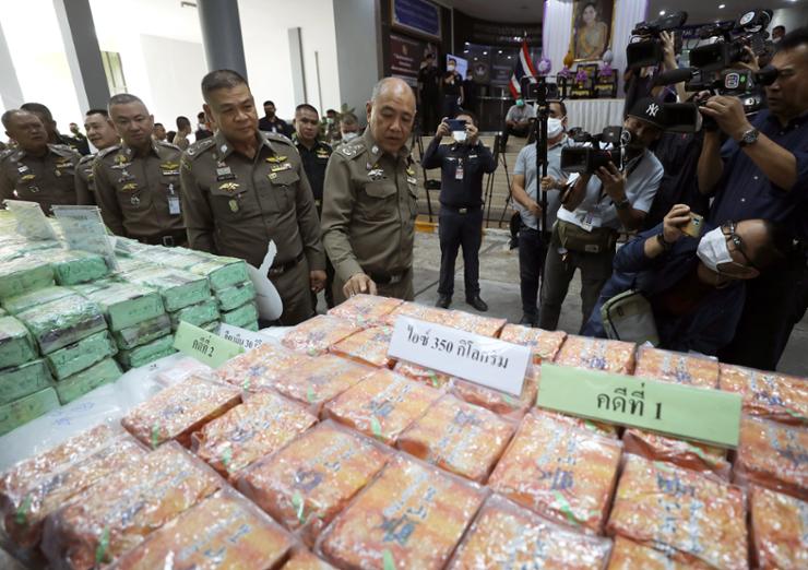 Thai national deputy police chief Chinnapat Sarasin, center, looks on confiscated crystal methamphetamine and other drugs types during a press conference at the Narcotics Suppression Bureau in Bangkok, Thailand, June 13, 2023. EPA-Yonhap