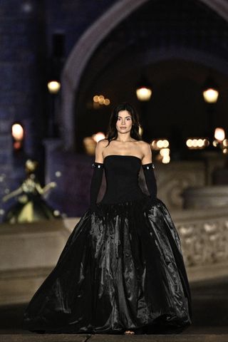 Kylie Jenner walks the Coperni runway wearing a black strapless dress