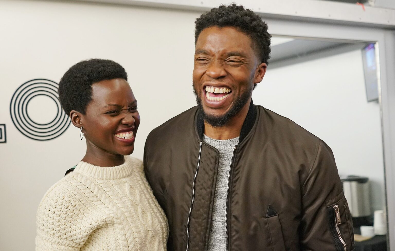 Lupita Nyong'o and Chadwick Boseman share a laugh in 2018