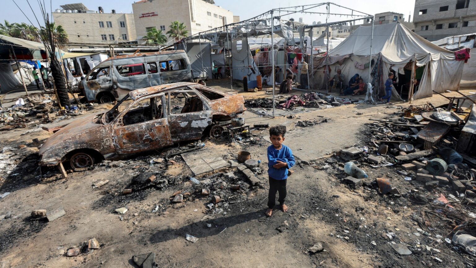 A boy looks on at the site of an Israeli strike on tents sheltering displaced people at Al-Aqsa hospital, where Palestinian Shaban al-Dalou was burnt to death, in Deir Al-Balah in the central Gaza Strip, October 15, 2024. REUTERS/Ramadan Abed TPX IMAGES OF THE DAY