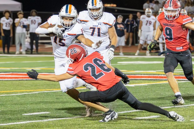 Oswego's Donovan Williams (15) runs the ball against Yorkville during a Southwest Prairie - West Conference game in Yorkville on Friday, Oct. 11, 2024. (Troy Stolt / for the Beacon-News)