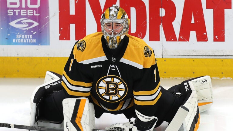 Boston Bruins goaltender Jeremy Swayman (1) stretches during pregame warmups.