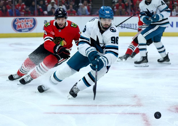 Chicago Blackhawks center Craig Smith (left) and San Jose Sharks defenseman Jake Walman (96) battle in the first period of the Blackhawks home opener at the United Center in Chicago on Oct. 17, 2024.  (Chris Sweda/Chicago Tribune)