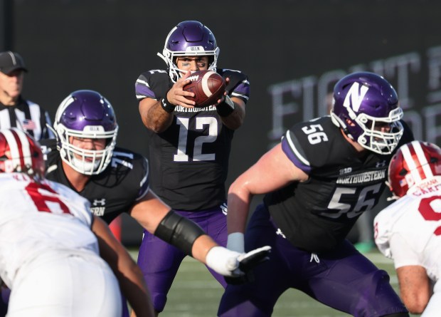 Northwestern Wildcats quarterback Jack Lausch (12) takes the snap in the third quarter against the Indiana Hoosiers at Martin Stadium on the Northwestern University campus on Oct. 5, 2024, in Evanston. (John J. Kim/Chicago Tribune)