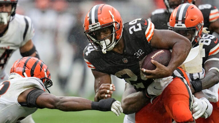 Cleveland Browns running back Nick Chubb (24) is pressured by Cincinnati Bengals safety Dax Hill, left, during an NFL football game, Sept. 10, 2023, in Cleveland.