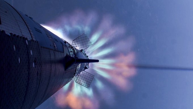 a view below Starship showing a plume of rocket exhaust