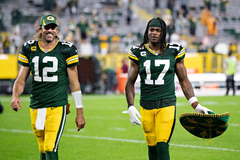 NFL players walk off field after game.