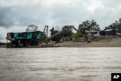 A machine used in extracting gold sits on Rio Quito — the Atrato River's main tributary — near Paimado, Choco state, Colombia, Sept. 23, 2024.