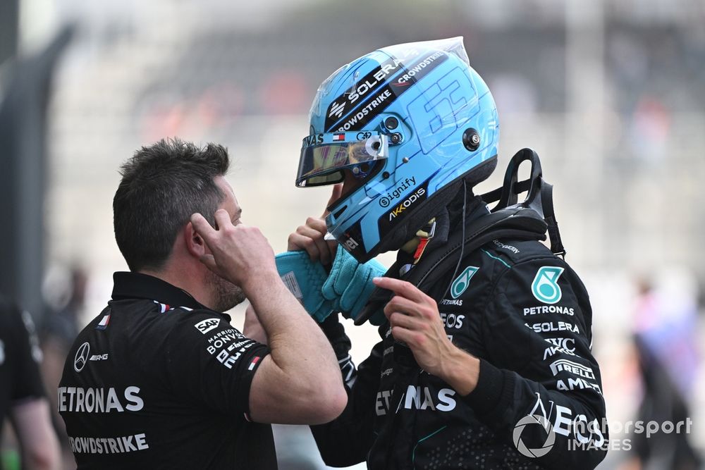 George Russell, Mercedes-AMG F1 Team, talks with a teammate