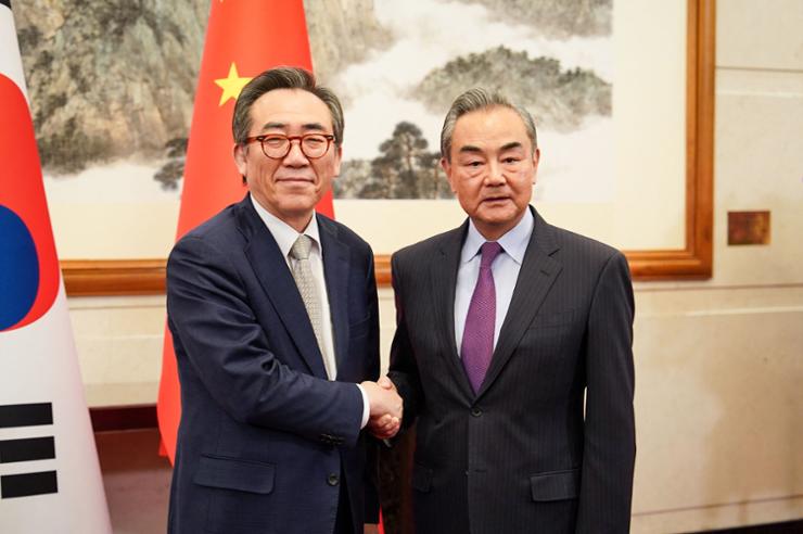 This handout photo taken, May 13, and provided by South Korean Foreign Ministry shows Chinese Foreign Minister Wang Yi, right, shaking hands with South Korea's Foreign Minister Cho Tae-yul during their meeting in Beijing. AFP-Yonhap