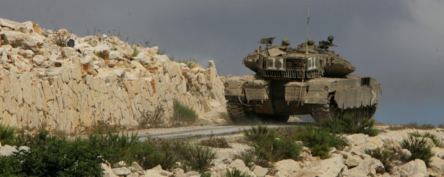 An Israeli Merkava tank drives up a hill to take positions inside Lebanon near the southern city of Marwaheen, Lebanon, - Sputnik International, 1920, 16.10.2024