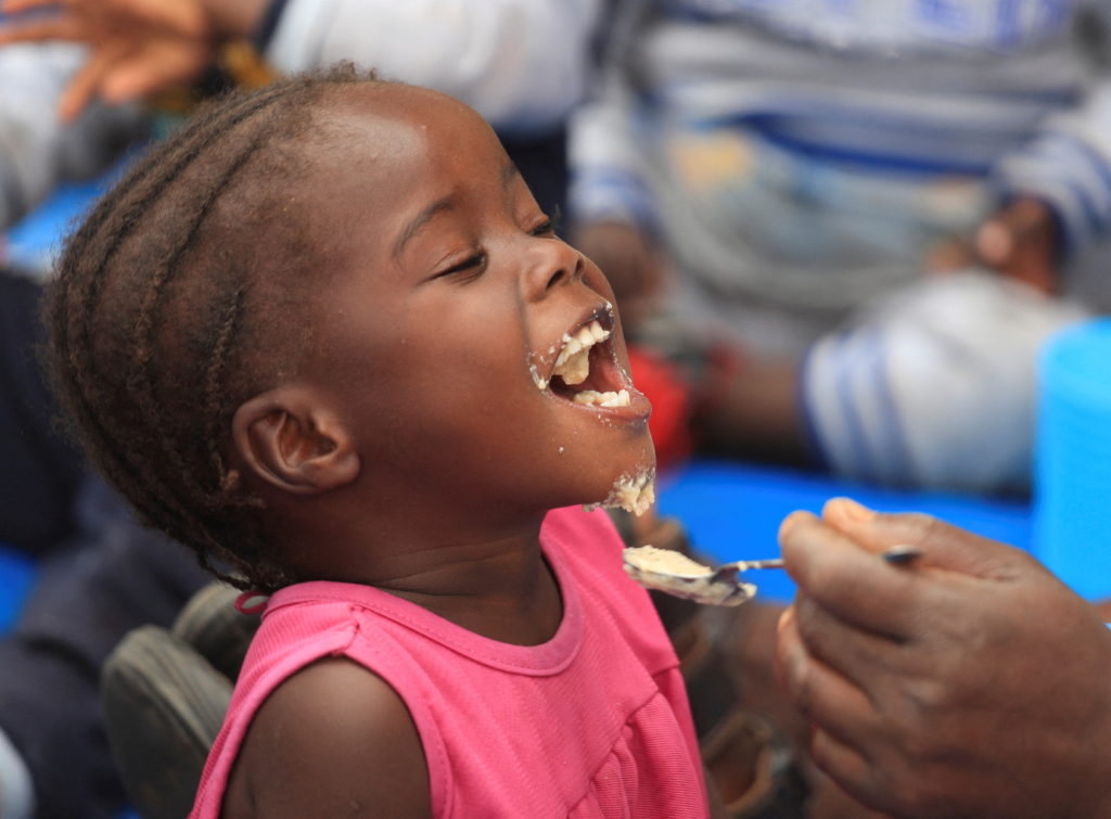 A child eats traditional porridge at a rural home, in Kotwa, Mudzi district