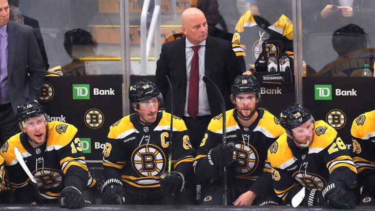 The Bruins bench is glum with seconds remaining in the game with them trailiung, 5-2, as coach Jim Montgomery stands behind (l to rt) Boston Bruins center Charlie Coyle (13), Boston Bruins left wing Brad Marchand (63), Boston Bruins center Pavel Zacha (18) and Boston Bruins center Elias Lindholm (28).