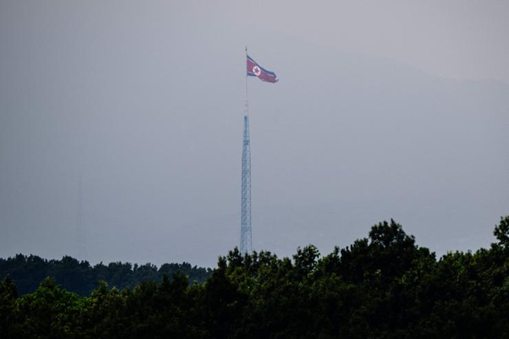 This picture taken from Paju on July 30, 2024 shows a North Korean flag fluttering in the wind at the propaganda village of Gijungdong in North Korea. A North Korean defector to the South was apprehended after he crashed a stolen bus near the border in a failed bid to return to his isolated homeland, police told AFP on Oct. 2. AFP-Yonhap