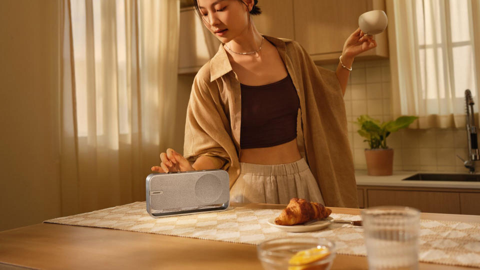 A person using the Bose SoundLink Home speaker while cooking in a kitchen.