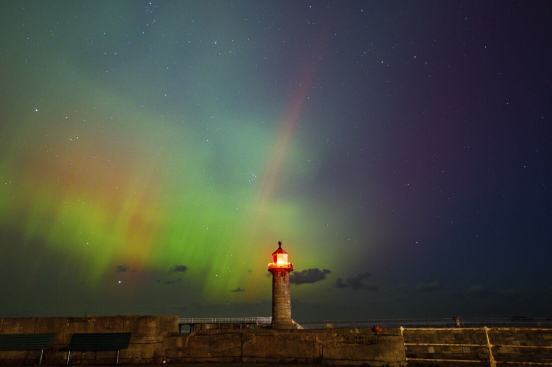 The northern lights, also know, as the aurora borealis, shines across Whitby Harbour, Whitby, UK, on Oct. 10.