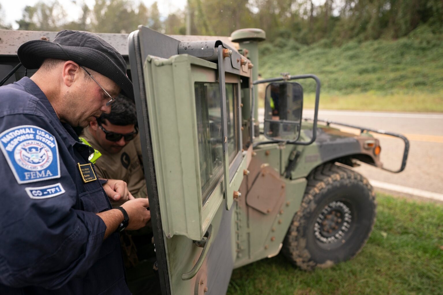 PHOTO: In this Sept. 30, 2024 file photo A FEMA response team member works with a guard member  at Crooked Creek Fire Department near Old Fort in the aftermath of Hurricane Helene  in Old Fort, N.C.