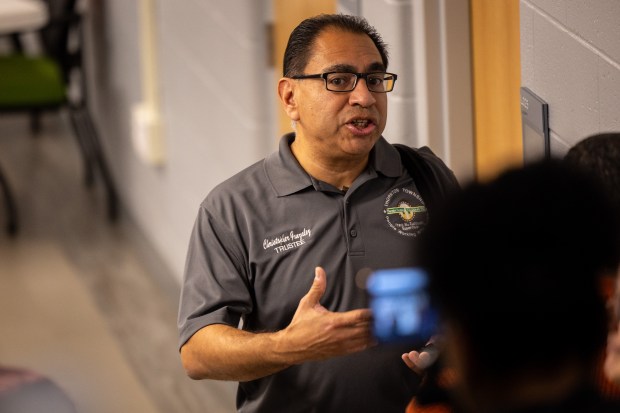 Thornton Township Trustee Chris Gonzalez talks to attendees downstairs after Thornton Township Supervisor Tiffany Henyard canceled the meeting upstairs because there were not enough trustees present at the Thornton Township Board meeting Oct. 22, 2024. (Tess Crowley/Chicago Tribune)