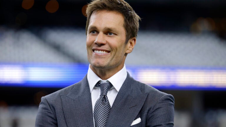 Fox Sports lead NFL analyst Tom Brady stands on the field during warmups before an NFL football game between the Detroit Lions and the Dallas Cowboys in Arlington, Texas, Sunday, Oct. 13, 2024.