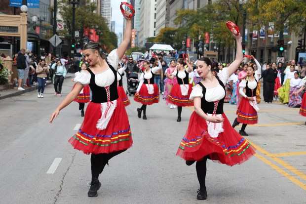 Honoria Ivankovich, left, and Gabriella Greco-Scott, of Christine Belpedio's School of Dance, perform in Chicago's Columbus Day Parade on State Street in Chicago on Oct. 14, 2024. (Terrence Antonio James/Chicago Tribune)