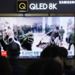 A TV screen shows an image of soldiers believed to be from North Korea stand in line to receive supplies from Russia during a news program at Seoul Railway Station in Seoul, South Korea, Monday, Oct. 21, 2024.