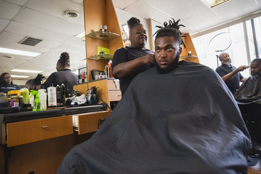 Cherita Evans aka Storm the Barber, with Christian Pounds in her chair at Head Changerz Barber Lounge in Rocky Mount, N.C. on May 23, 2024.