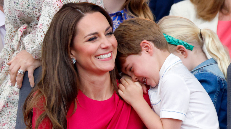 Prince Louis giggles on Kate Middleton's shoulder