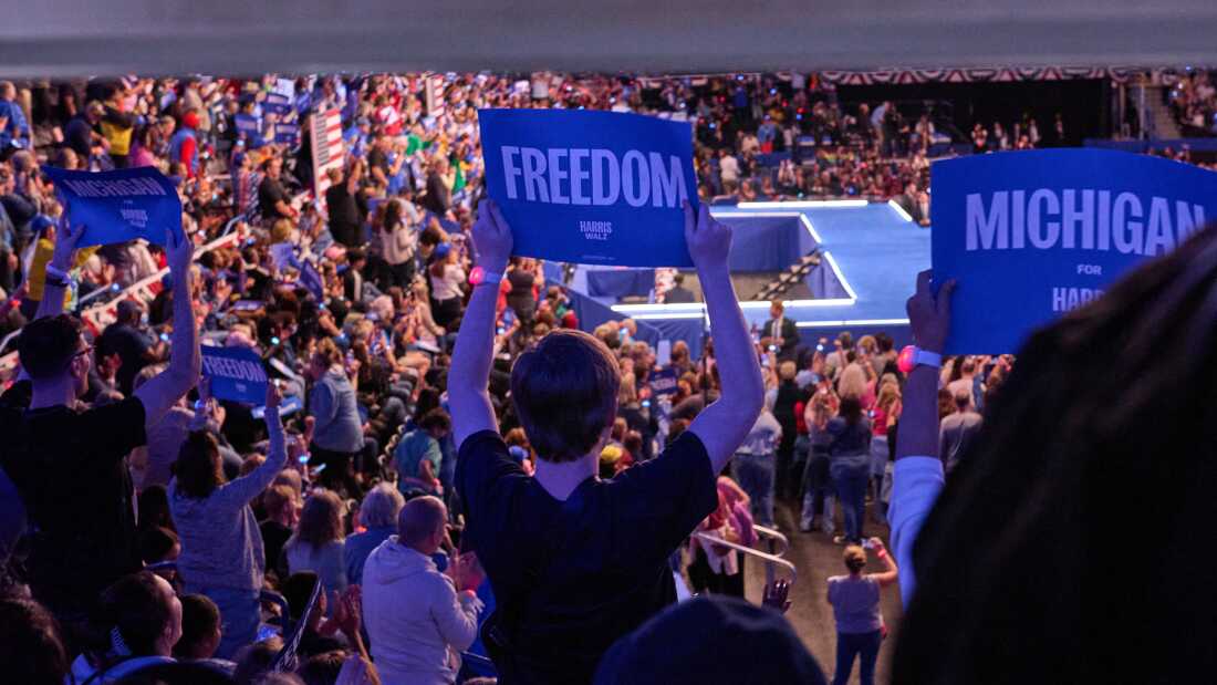 Supporters watch Vice President Harris speak during a rally in Flint, Mich.