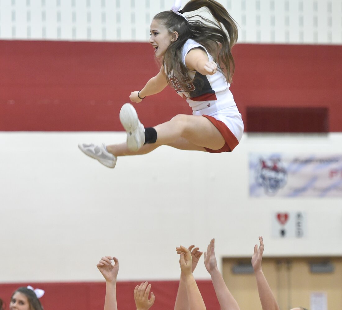 Fleetwood High School cheerleader Samantha Colelli, 17, a senior at Fleetwood, does a basket during halftime at a game in 2017. As cheerleading has become more ambitious over the last decade, it's also become riskier warn pediatricians.