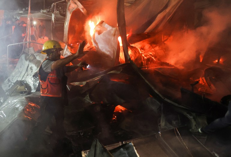 A rescuer works at the site of an Israeli strike on tents sheltering displaced people, amid the Israel-Hamas conflict, in Deir Al-Balah in the central Gaza Strip, October 14, 2024. REUTERS/Ramadan Abed